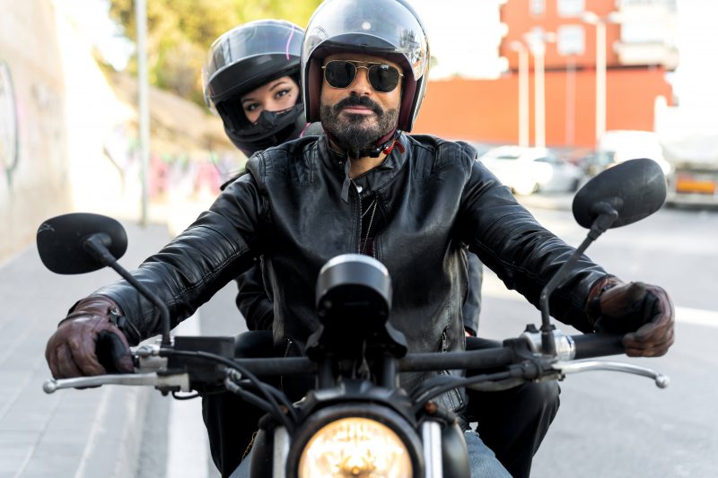 Driver and passenger Wearing helmets on motorbike