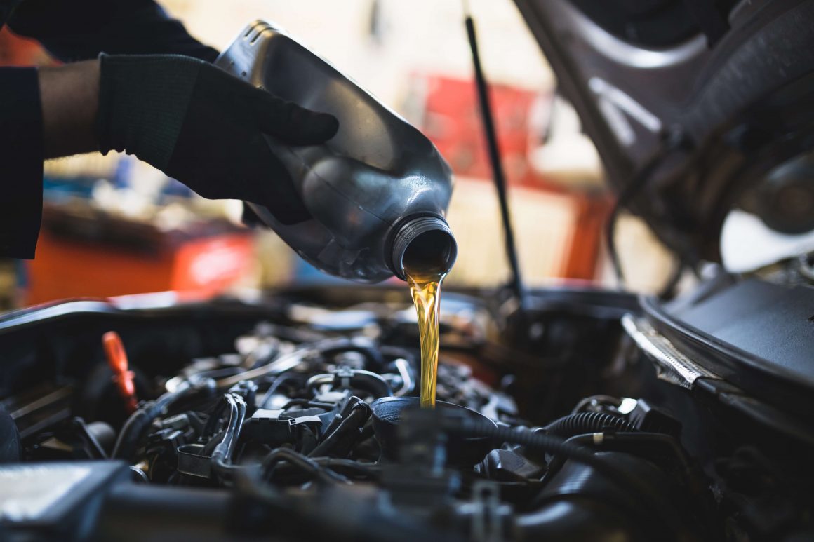 Putting clean oil into a car
