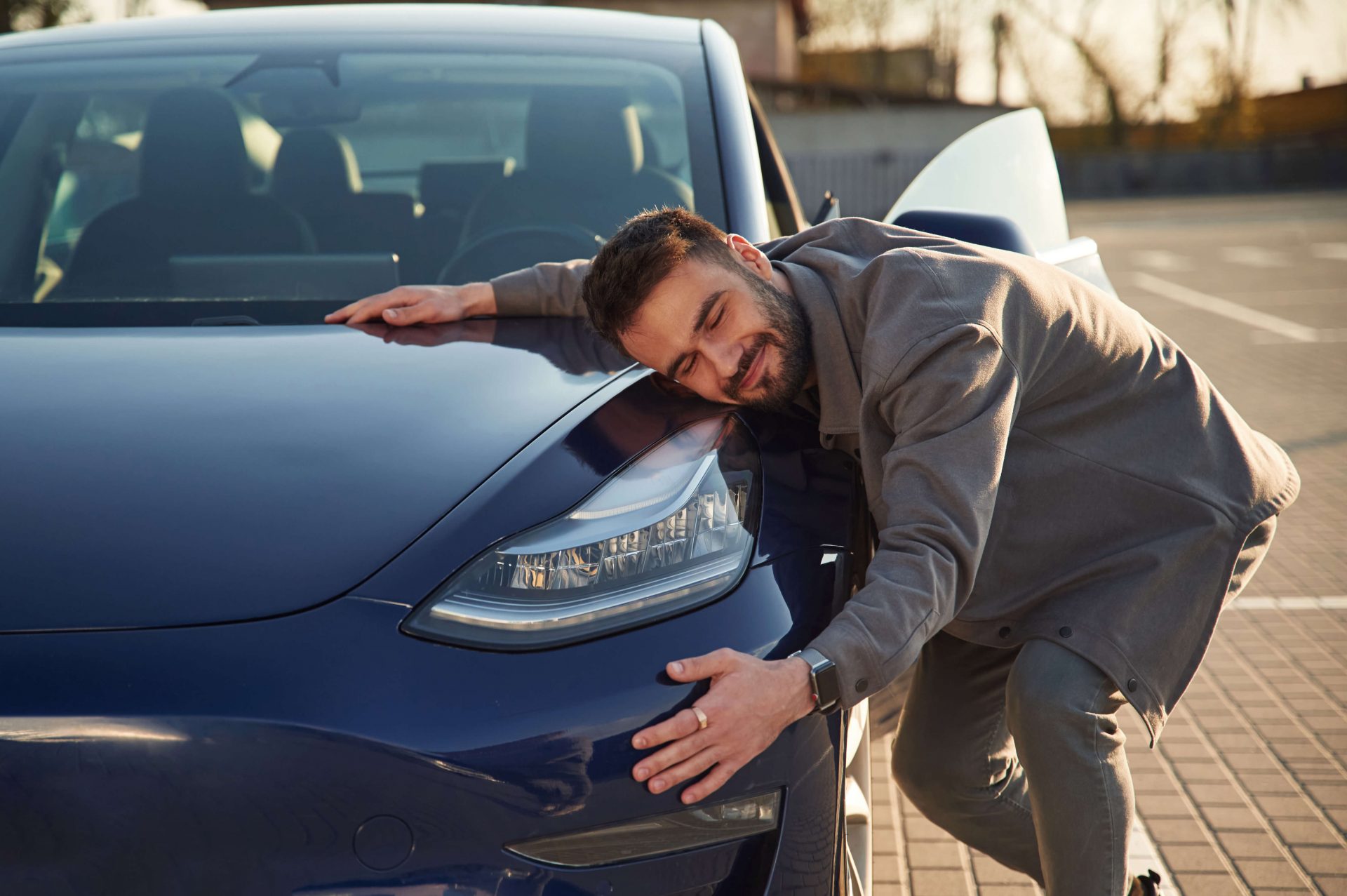 Man hugging car