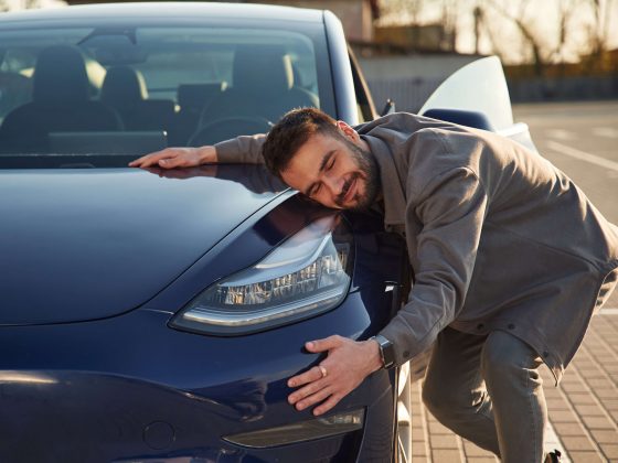 Man hugging car