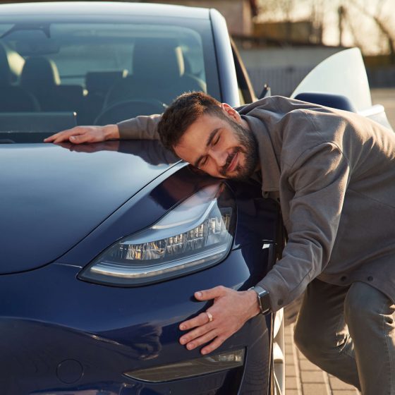 Man hugging car