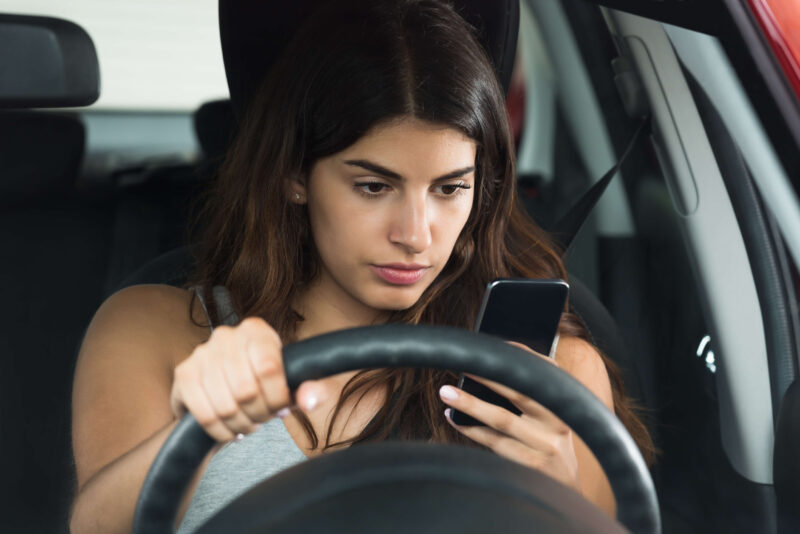 Holding a cell phone while driving