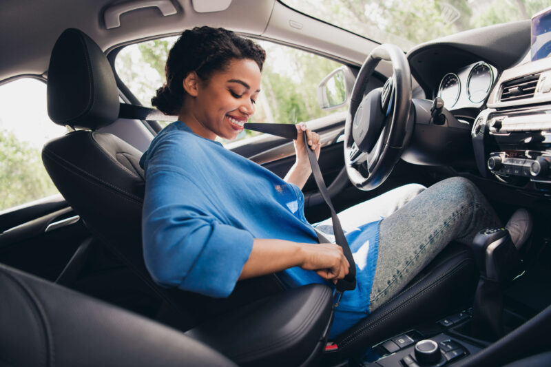 Woman buckling her seatbelt
