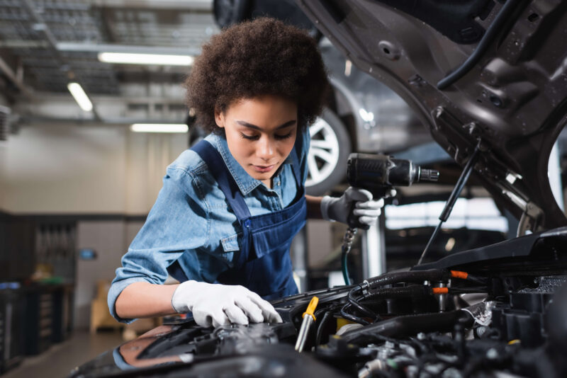 Woman performing car maintenance