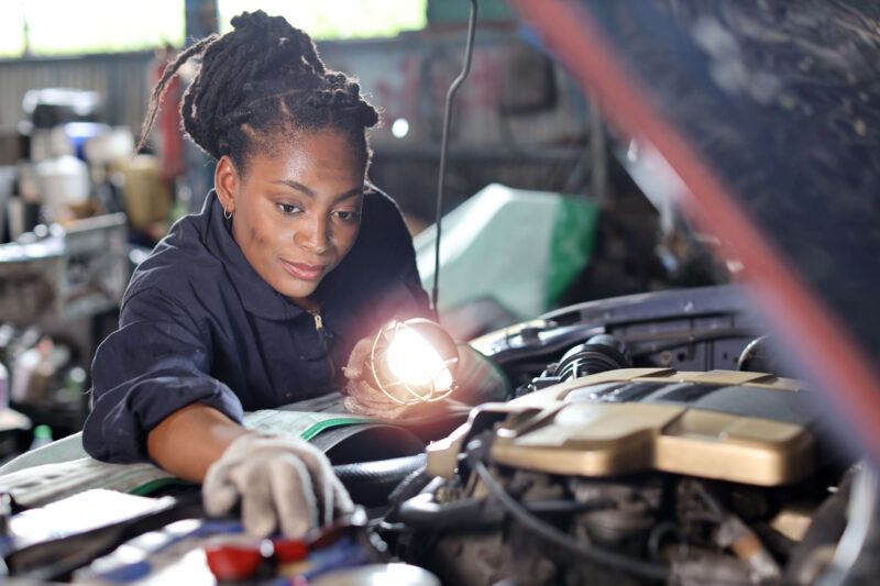 Mechanic inspecting car engine