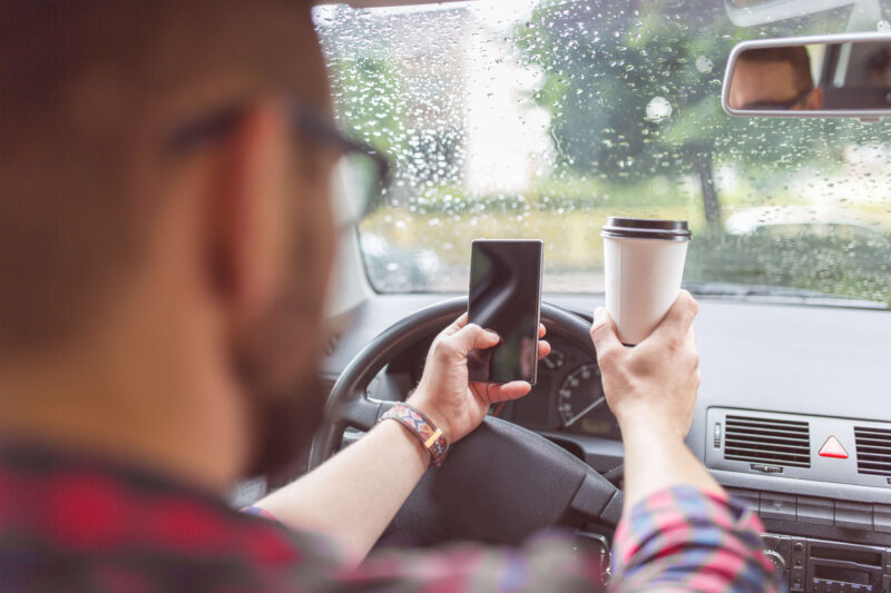 Checking messages and drinking coffee while driving